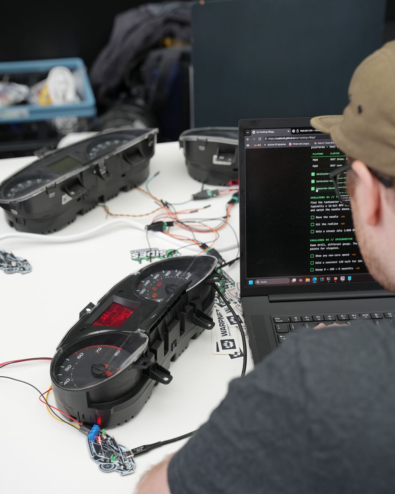 A powered Škoda Fabia instrument cluster on a workshop bench beside a laptop running the WebUSB CAN console.